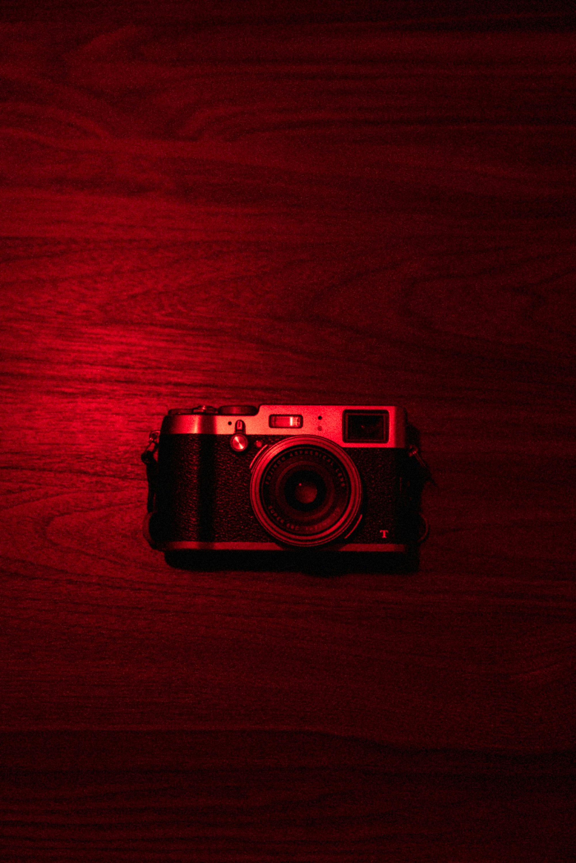 black and silver camera on brown wooden table